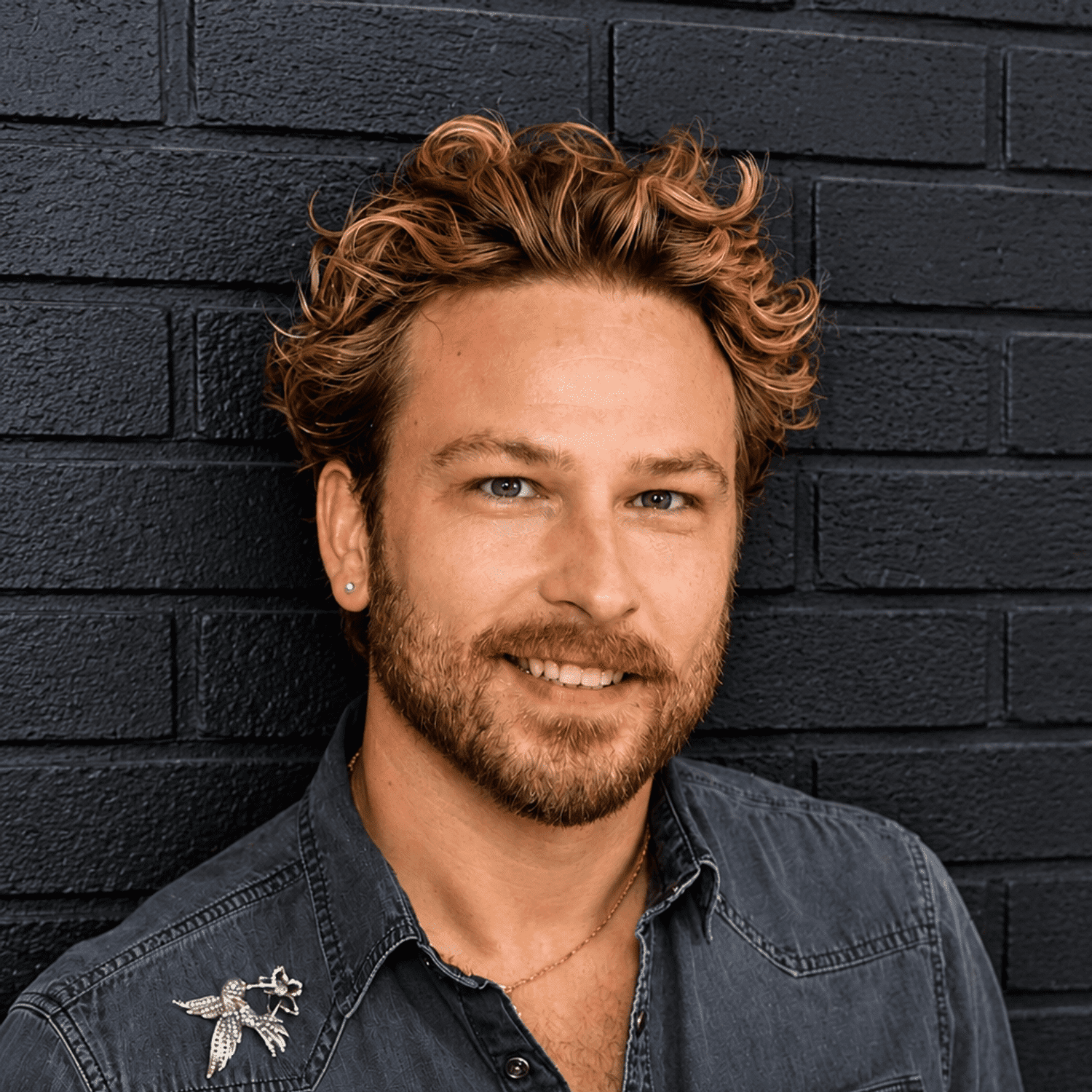 Portrait of Gunnar Goodwin, a professional stylist at Educe Salon, showcasing their expertise and style.