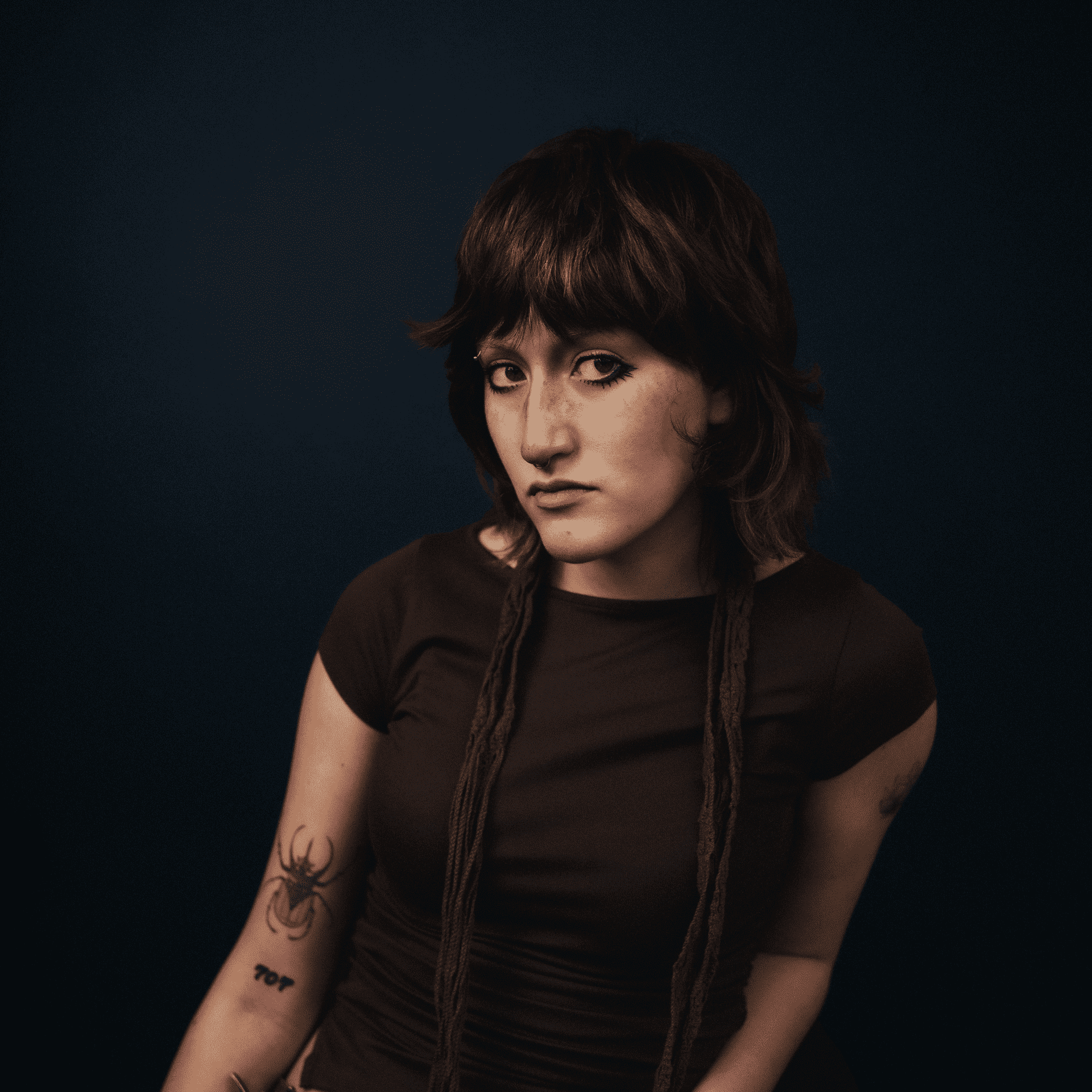 Portrait of Sam, a professional stylist at Educe Salon, showcasing their expertise and style.